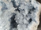 a close up of a piece of crystal on a rock