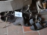 many pairs of shoes that are tied up on the floor