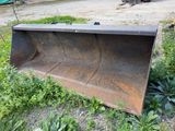 a bulldozer that is sitting in the grass