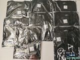 a lot of black t - shirts on a white table