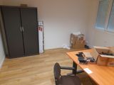 a desk with a computer and a chair in a room
