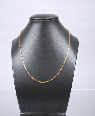 a gold chain necklace on a mannequin display