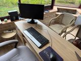 a desk with a keyboard, mouse, and monitor on it