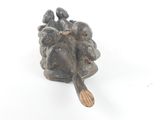 a figurine of a man and a woman sitting on a rock