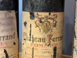 three bottles of wine sitting on a table with a blue wall in the background