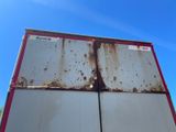 a rusted metal container on the back of a truck
