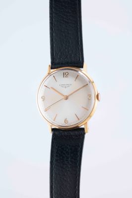 a close up of a watch on a black leather strap