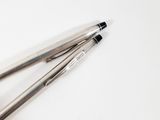 two pens that are sitting on a white surface