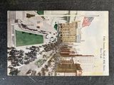 an old postcard with a picture of a city street
