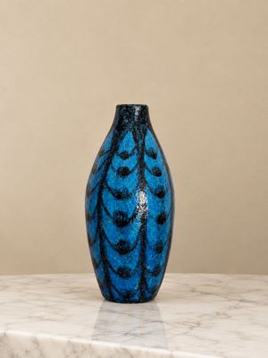 a blue vase sitting on top of a marble table