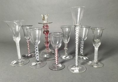 a group of wine glasses sitting next to each other on a table