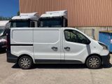 a white van parked in a parking lot next to a building