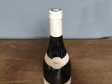 a bottle of wine sitting on a wooden table