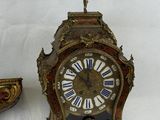 two clocks sitting next to each other on a table