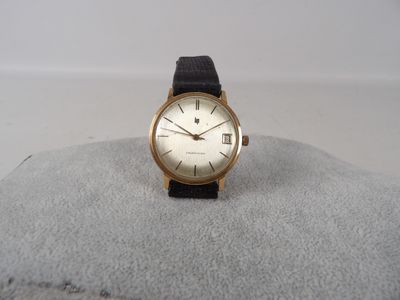 an image of a gold wrist watch with a black strap