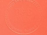 the back of a red book with a stamp on it