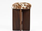 an image of a stool with a cow hide on it