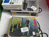 a box of bosch tools on a table next to a red container