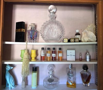 a shelf with a lot of perfume bottles and perfume bottles on it