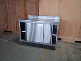 a stainless steel cabinet in the middle of a room