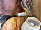 a pile of wicker baskets and a lamp on a shelf