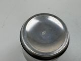 a silver container sitting on a table with a lid