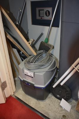 an image of a room with a vacuum and a red carpet