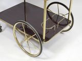 a black and gold bar cart on wheels on a white background
