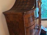 a dresser with a mirror on top of it in a room
