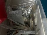 a plastic container filled with assorted items sitting on a table