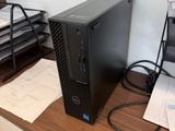 a desktop computer sitting on a desk next to a printer