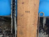 a wooden sign that is sitting in front of a row of blue chairs
