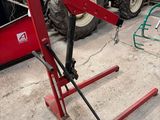 a red machine that is parked in a garage