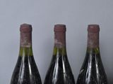 three bottles of wine that are sitting on a table