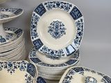 many blue and white plates and bowls on the table