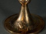 a gold candle that is sitting on top of a table