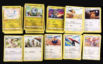 a lot of pokemon cards that are on the table