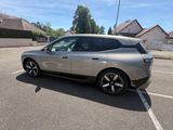 a silver car that is parked in a parking lot
