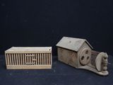 a small bird cage and a small bird house on a table