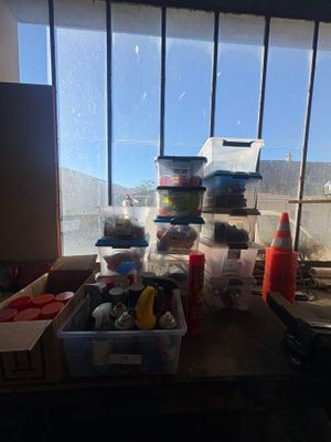 a table with a lot of stuff on it in front of a window