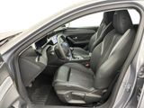 the interior of a car with the door open and the driver ' s seat down