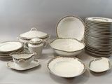a lot of plates and bowls that are on the table