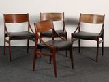three wooden chairs with black leather upholstered seats in a room