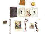 a small collection of religious items on a white surface
