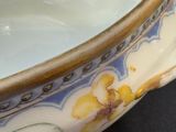 a bowl with a flower design on it on a table