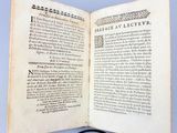 an open book with a magnifying glass on top of it