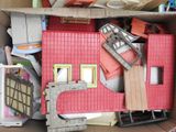 a cardboard box filled with toys and other items