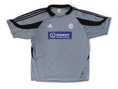 a close up of a soccer jersey with a logo on it