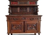an old wooden cabinet with carvings on top of it