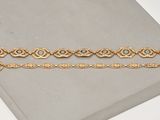 a close up of a book with a gold bracelet on it